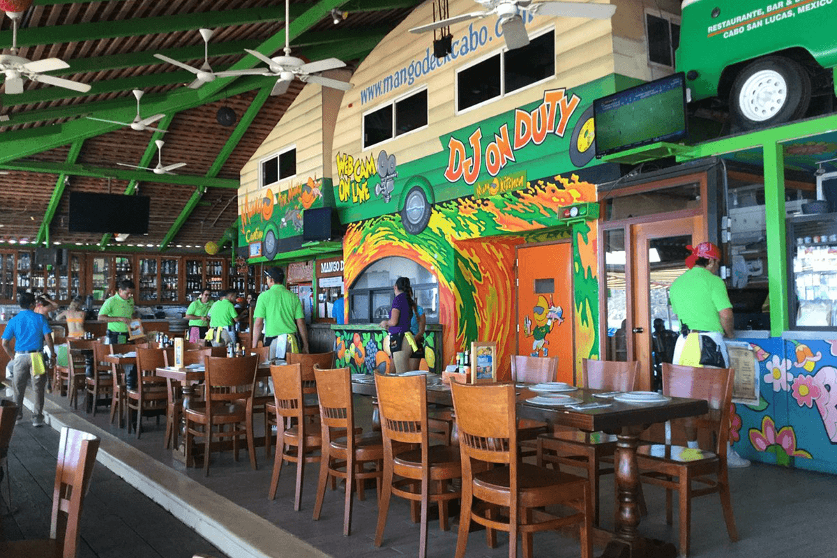 Colorful open-air dining room and bar at Mango Deck on Médano Beach