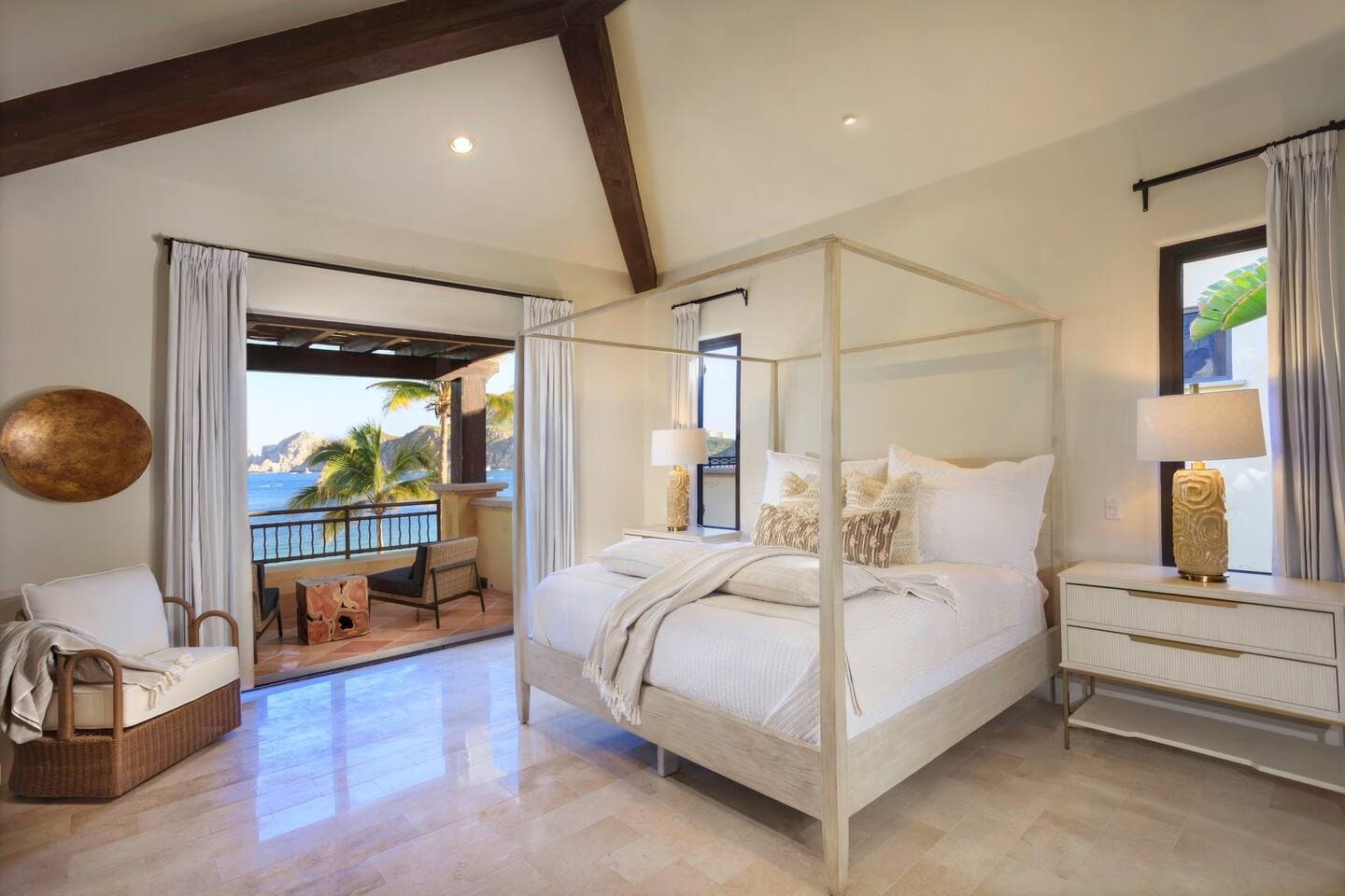 Master bedroom with canopy bed and balcony