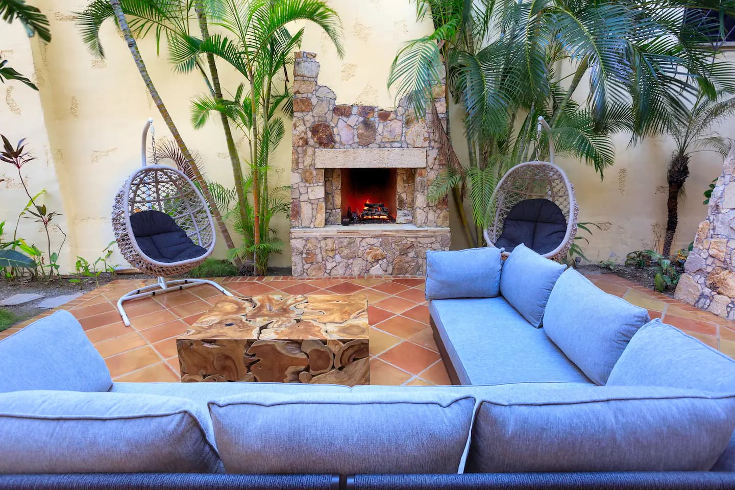 Private patio with open fire and lounge sofas