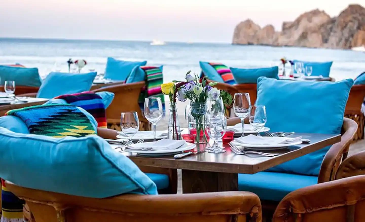 Beachfront table setting at Hacienda Beach Club with Land's End beyond