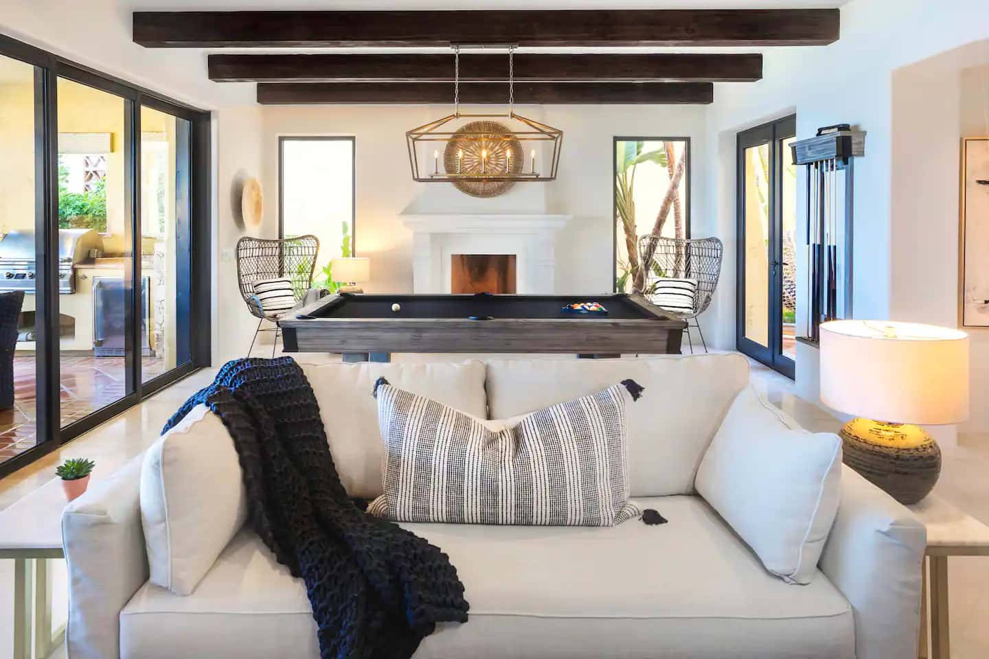 Living room with pool table and ocean views