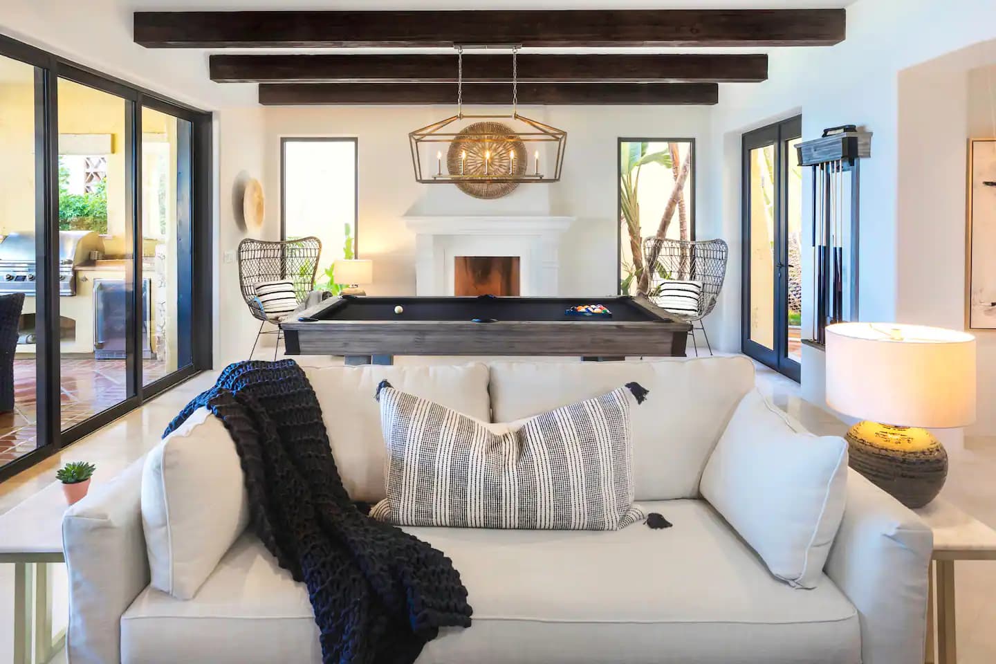 Living room with pool table and ocean views at Villa 1